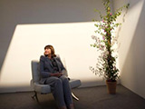 Commissioner sitting in a cube with artificial daylight at the Euro Open Science Forum 2014