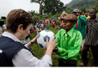 Commissioner Georgieva hands out donated soccer balls to the local chairman in Kitutu (c) EU
