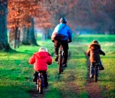 Family cycling in park