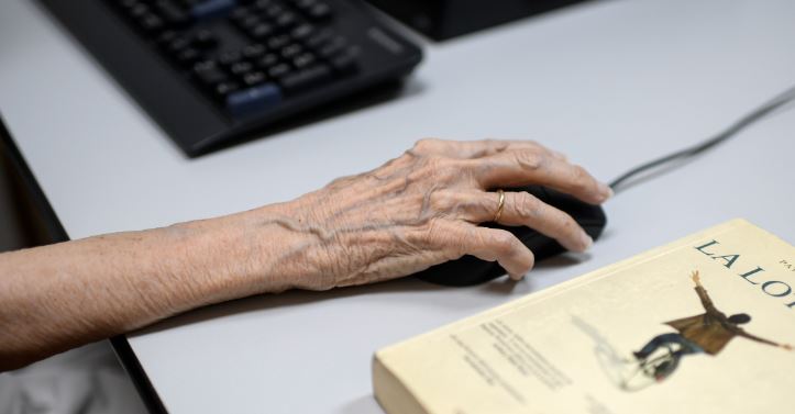 Hand of an elderly people using a computer in a day care 