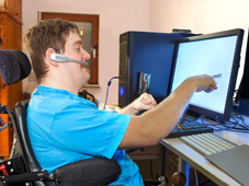 Young man using a wheel chair with mobility and dexterity impairments
