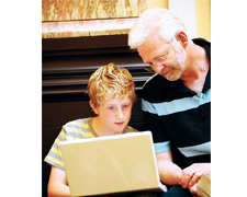 Man and child looking at a computer © European Commission
