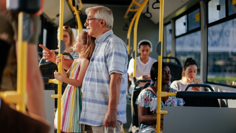 People of diverse ages and background riding together in public transport.