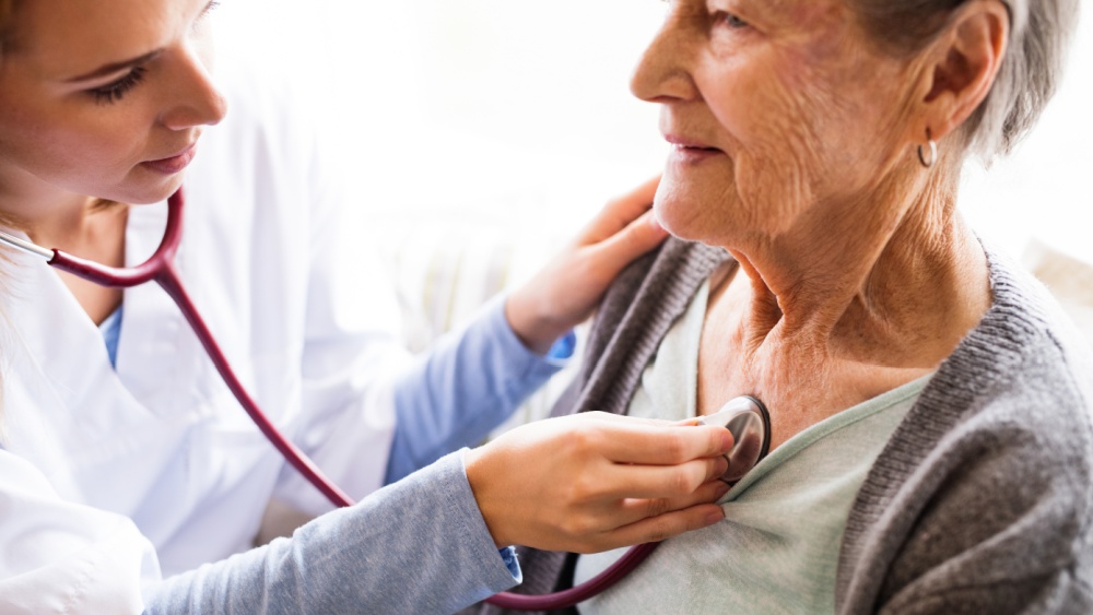 Older person being checked with a stethoscope.