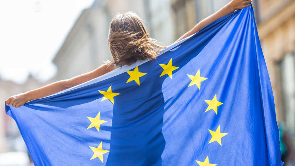 a woman holding the EU flag