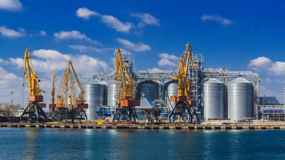 An industrial harbour with cranes and silos are shown in the picture
