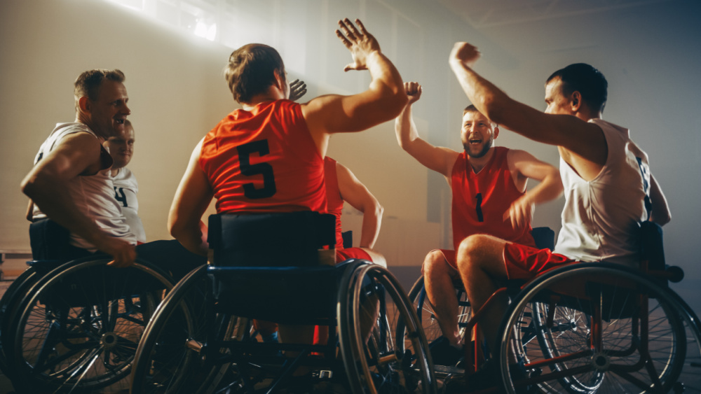 people on wheelchairs cheering in a game.