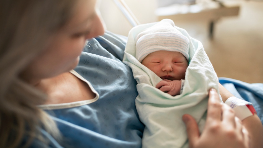 A woman holding a baby.