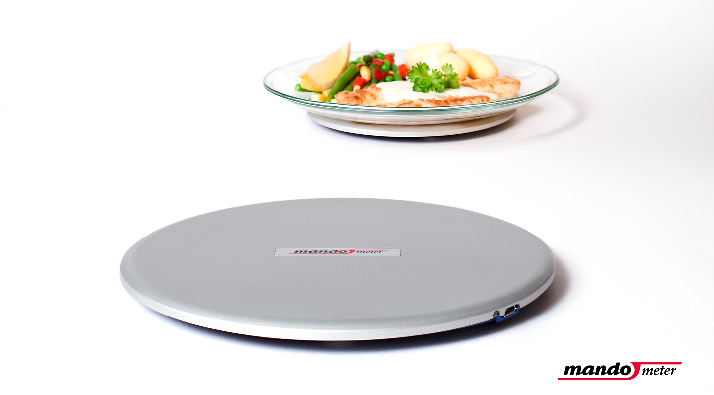 Mando has developed a thin scale that sits under users' plate and communicates wirelessly with their smartphone, allowing feedback regarding their intake rate Thin scale developed by Mando that sits under the plate and communicates wirelessly with the user's smartphone, allowing feedback regarding their intake rate