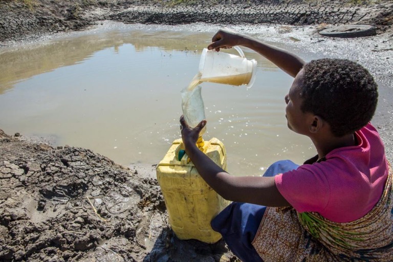 Woman pouring water, Igunga, Tanzania