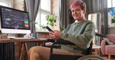 Person with disabilities sitting on a wheelchair and working online