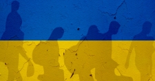 Ukrainian Refugees shadow under the Ukrainian flag.