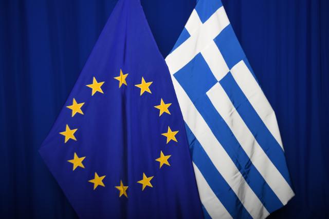 The national flag of Greece next to the European flag