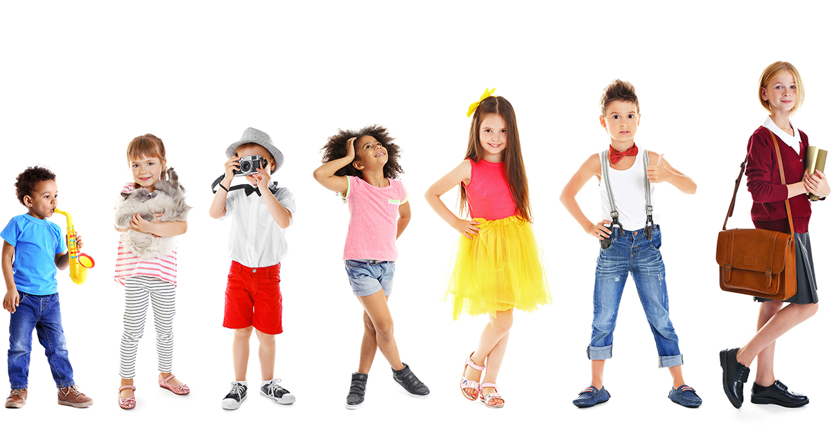 Children posing in a growing row going from the younger to the older