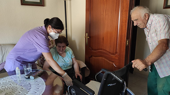 rural care worker assisting older Spanish citizens
