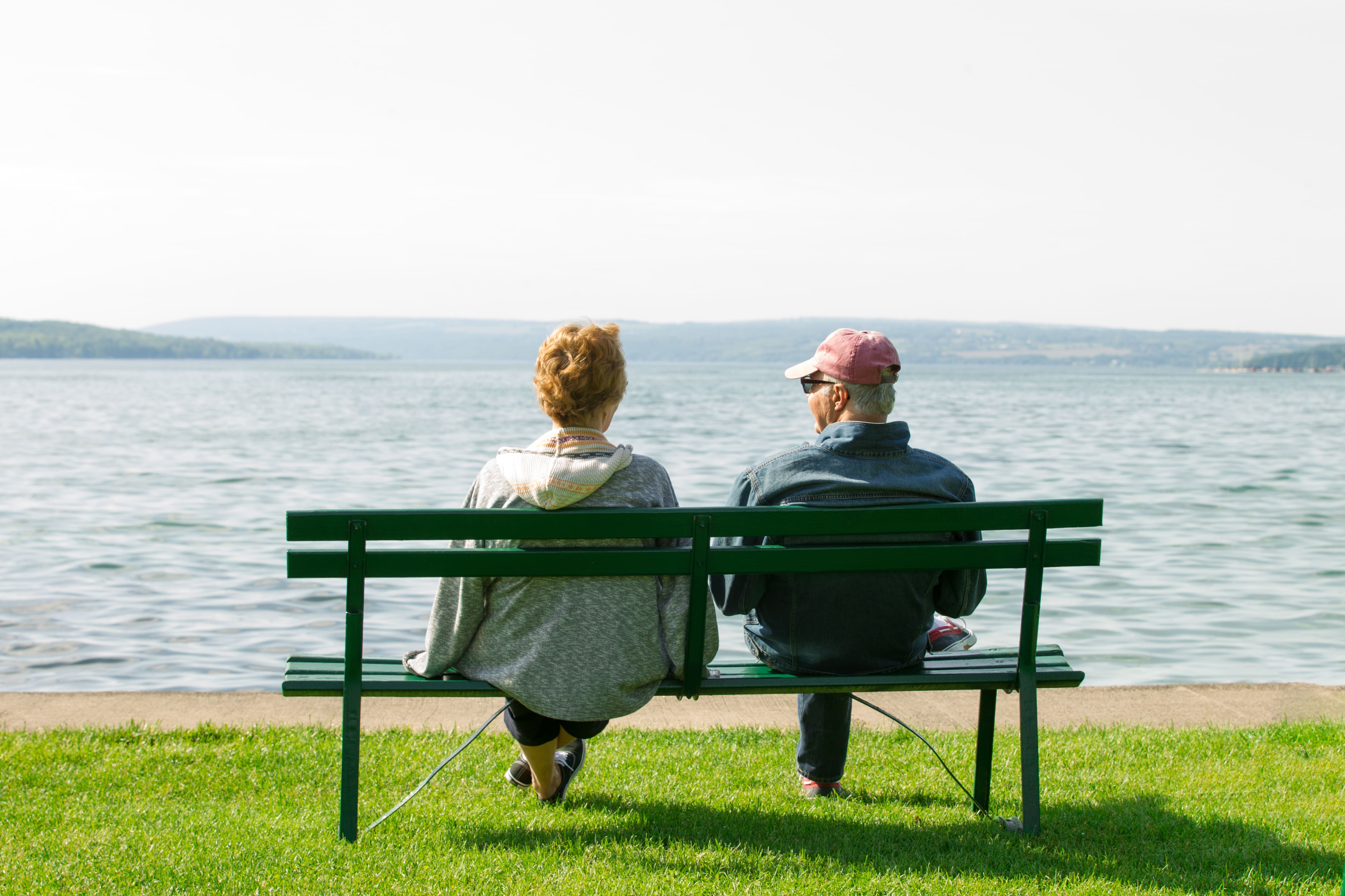 Elderly people sitting in a bench