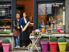 Two female entrepreneurs in front of their shop